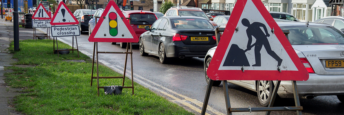 roadworks signs next to busy road