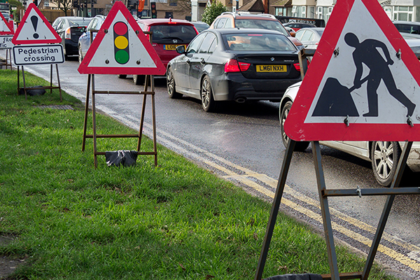 roadworks signs next to busy road
