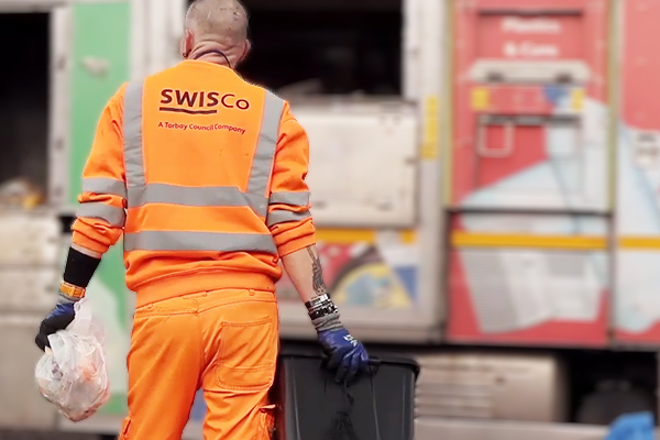 recycling crew from rear with blurred recycling vehicle in background
